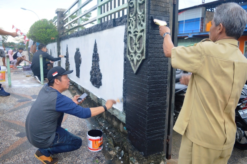Jadi Motivasi, Pjs Bupati Kapuas Mengecat Tembok Lapangan